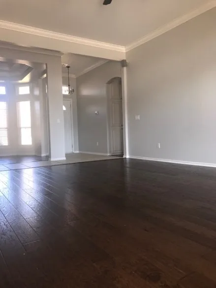 Freshly painted gray living room walls with white crown molding and trim by GG Painting & Drywall